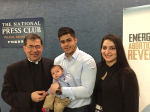 Father Frank Pavone, national director of Priests for Life, poses with Chris Caicedo, Andrea Minichini and their son, Gabriel Caicedo, following a news conference at the National Press Club in Washington Feb. 23 to call attention to a protocol to reverse RU-486 medical abortions. (CNS photo/Priests for Life) See ABORTION-REVERSAL Feb. 24, 2015.